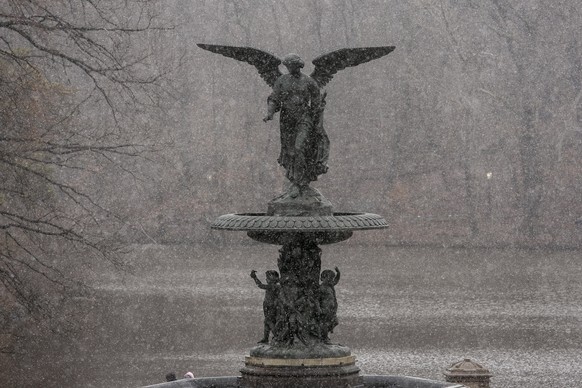 epa10522680 Snow from the season&#039;s first nor&#039;easter falls on the Angel of the Waters statue in Central Park in New York, New York, USA, 14 March 2023. The US National Weather Service (NWS) h ...