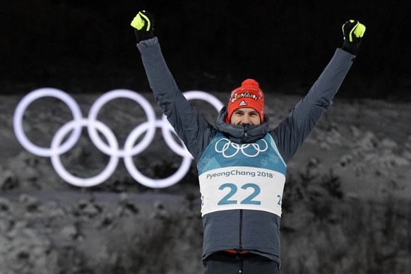 Arnd Peiffer, of Germany, celebrates his gold medal during the venue ceremony after the men&#039;s 10-kilometer biathlon sprint at the 2018 Winter Olympics in Pyeongchang, South Korea, Sunday, Feb. 11 ...