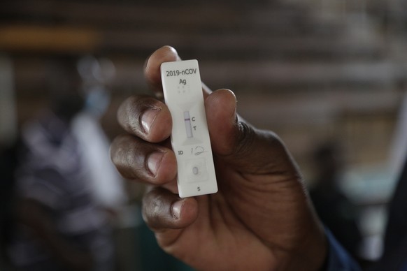 epa09744330 A negative covid-19 test displayed in Harare, Zimbabwe, 10 February 2022. The country has seen a decrease in the number of covid -19 positive cases as more and more people adhere to the strict health protocols  and get tested.  EPA/AARON UFUMELI