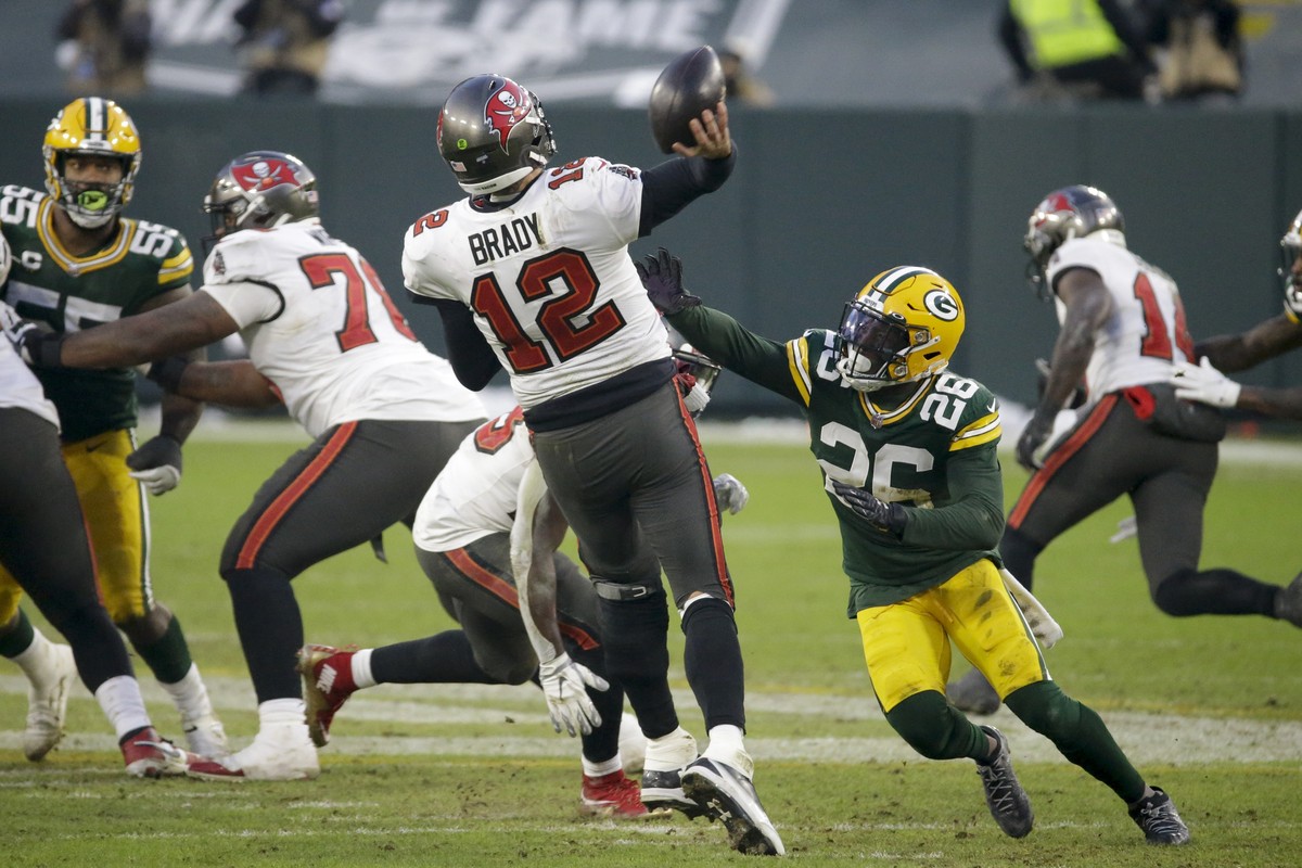 Green Bay Packers' Darnell Savage (26) puts pressure on Tampa Bay Buccaneers quarterback Tom Brady as he throws a pass intercepted by Green Bay Packers' Jaire Alexander during the second hal ...