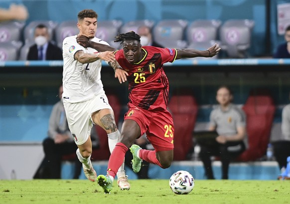 Italy&#039;s Giovanni Di Lorenzo, left, challenges for the ball with Belgium&#039;s Jeremy Doku during the Euro 2020 soccer championship quarterfinal match between Belgium and Italy at at the Allianz  ...