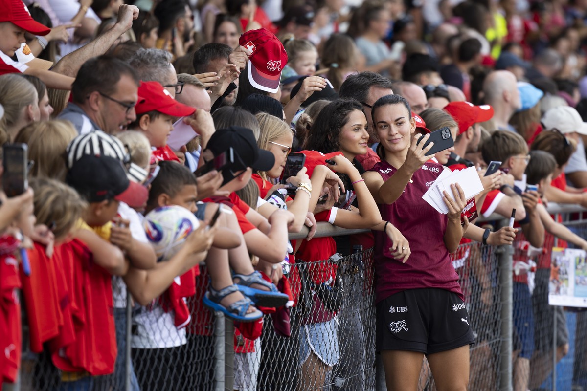 Switzerland's Riola Xhemaili poses for pictures with the fans, after a training session of the Swiss women's national soccer team at the Neufeld stadium in Bern, Switzerland, Sunday, July 13 ...