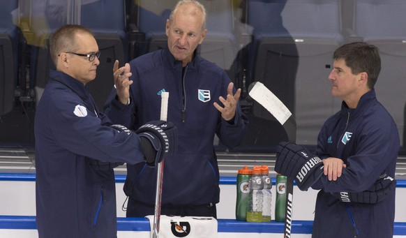 Team Europe head coach Ralph Krueger, center, chats with assistant coaches Paul Maurice, left, and Brad Shaw during the first practice session in preparation for the World Cup of Hockey tournament, Mo ...