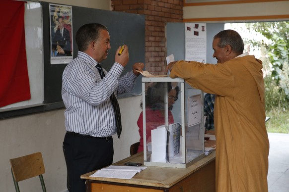 A man casts her ballot at a polling station for the parliamentary elections, in Rabat, Morocco, Friday, Oct. 7, 2016. Millions of Moroccans hit the voting booths, with worries about joblessness and ex ...