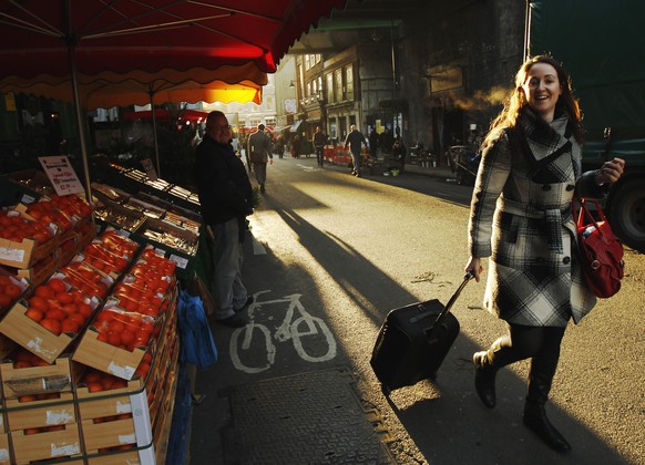 A woman walks through Borough Market in London in this December 9, 2011 file photo. Planning a spring fling in London? There&#039;s no better season to visit the British capital, when longer daylight  ...