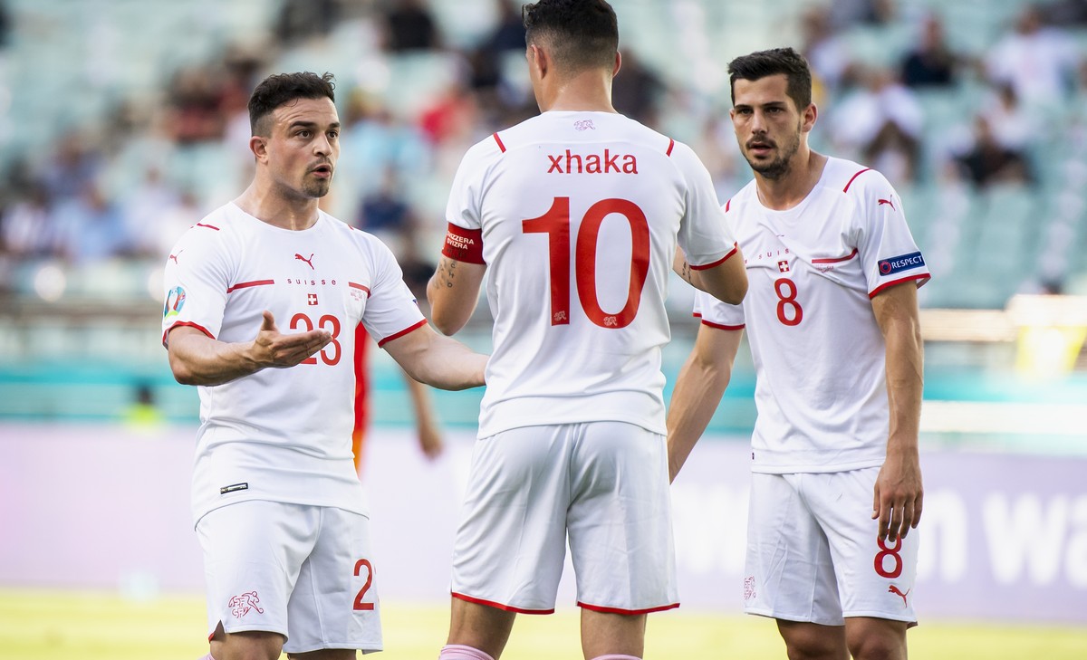 Switzerland's midfielder Xherdan Shaqiri, left, talks to Switzerland's midfielder Granit Xhaka and Switzerland's midfielder Remo Freuler during the Euro 2020 soccer tournament group A m ...