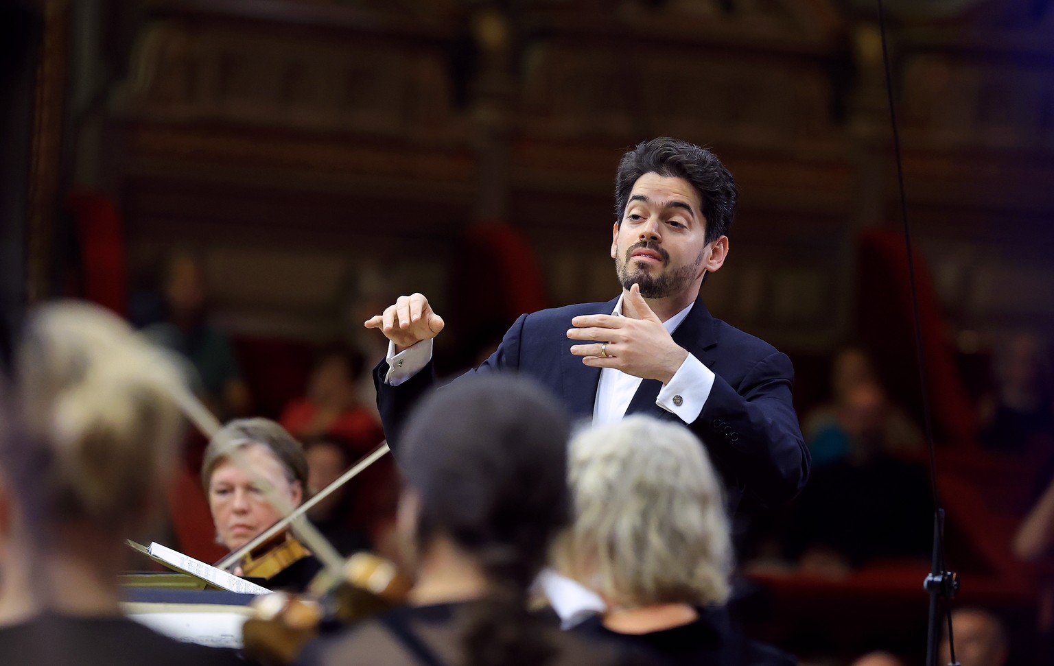 epa12355407 Israeli conductor Lahav Shani (R) performs with the Rotterdam Philharmonic Orchestra the Intermezzi for string instruments op. 12 of George Enescu on stage at the Romanian Athenaeum concer ...