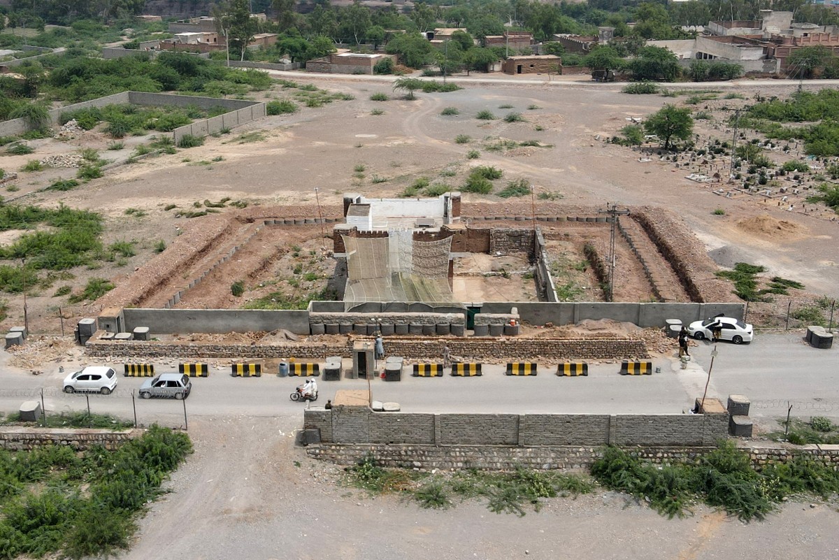 This photograph taken on August 4, 2026 shows security personnel fortifying a police post with Ukraine-style mesh barriers, as a new line of defence against militant drone and aerial attacks at Bara i ...