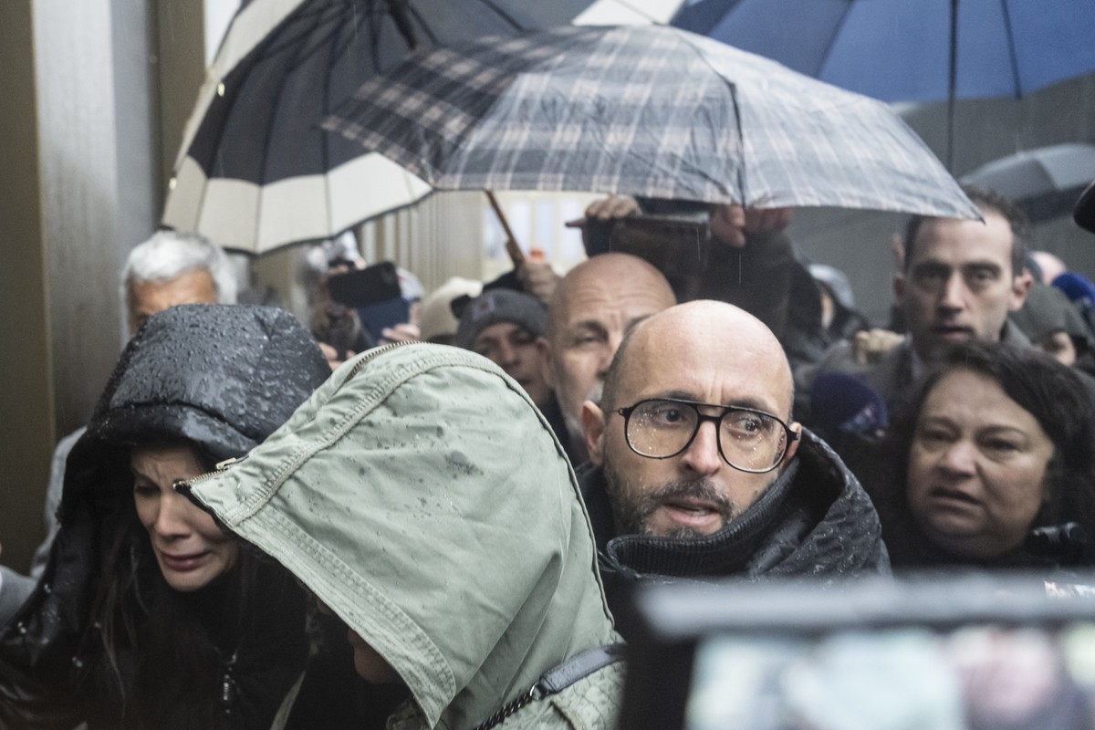 The owner of "Le Constellation" bar in Crans-Montana, Jacques, center, and Jessica Moretti, left, of France, are screamed at by a mother of a victim, right, ahead of the hearing before the p ...