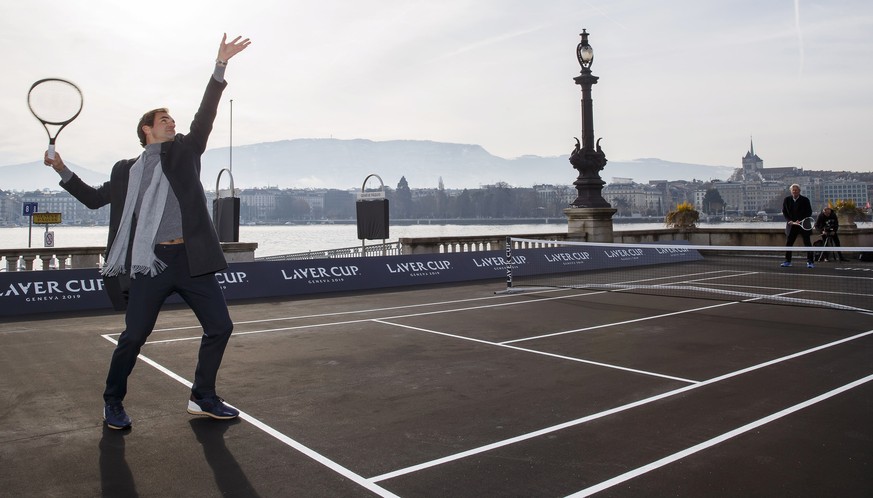 epa07352137 Roger Federer (L) of Switzerland serves to Team Europe&#039;s captain Bjorn Borg (R) of Sweden during a pre-event prior to the Laver Cup tennis event in Geneva, Switzerland, 08 February 20 ...