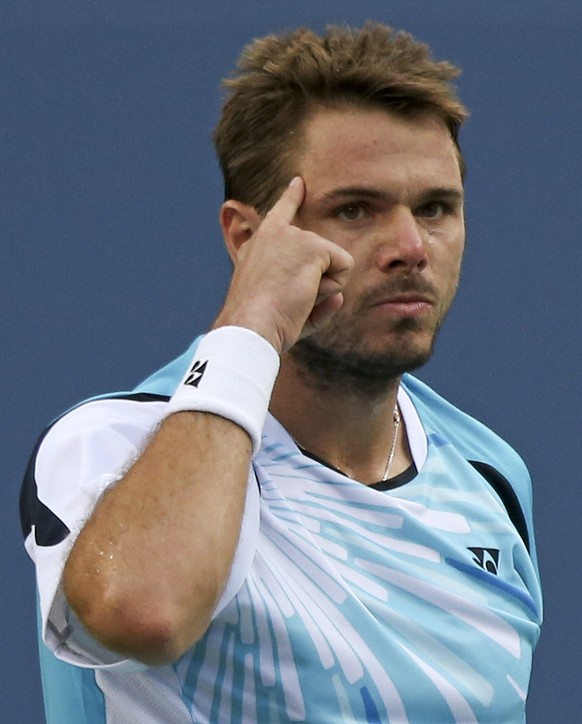 Stan Wawrinka, of Switzerland, points to his head after winning a point against Kei Nishikori, of Japan, during the quarterfinals of the 2014 U.S. Open tennis tournament, Wednesday, Sept. 3, 2014, in  ...