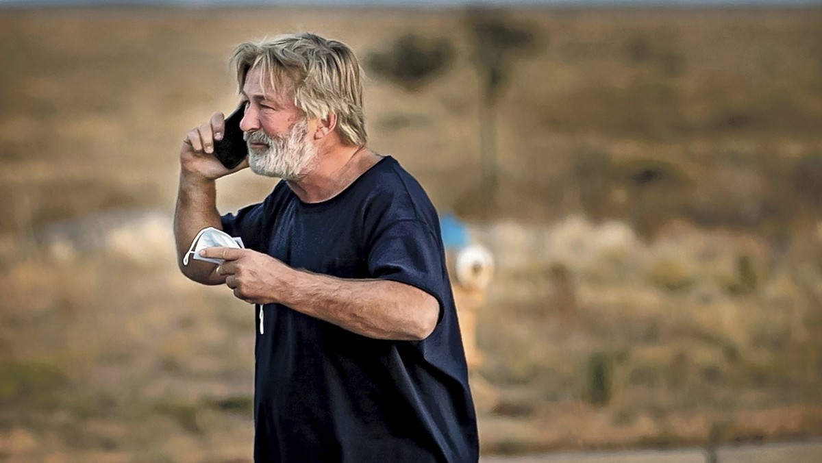 Alec Baldwin speaks on the phone in the parking lot outside the Santa Fe County Sheriff's Office in Santa Fe, N.M., after he was questioned about a shooting on the set of the film "Rust&quot ...