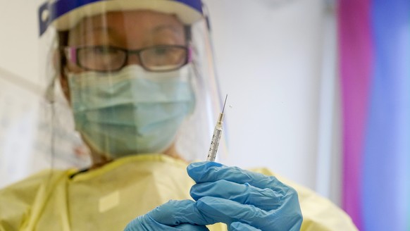 FILE - A physician assistant prepares a syringe with the monkeypox vaccine for a patient during a vaccination clinic Friday, Aug. 19, 2022, in New York. The disease