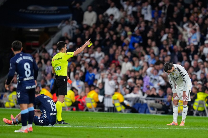 Real Madrid's Alvaro Carreras gets a second yellow card for a red card during the Spanish La Liga soccer match between Real Madrid and Celta Vigo in Madrid, Spain, Sunday, Dec. 7, 2025. (AP Photo ...
