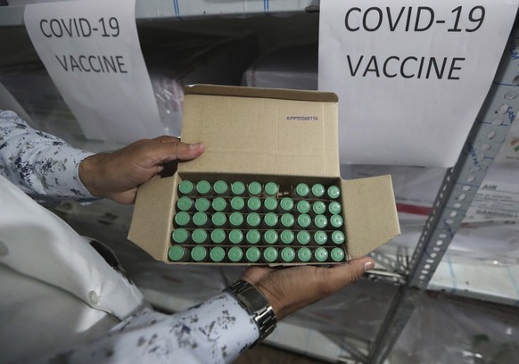 A health worker shows a box containing COVID-19 vaccine inside a cold storage at Civil Hospital in Ahmedabad, India, Tuesday, Jan. 12, 2021. On Jan. 16 India will start the massive undertaking of inoculating an estimated 30 million doctors, nurses and other front line workers, before attention turns to around 270 million people who are either aged over 50 or have co-morbidities. (AP Photo/Ajit Solanki)