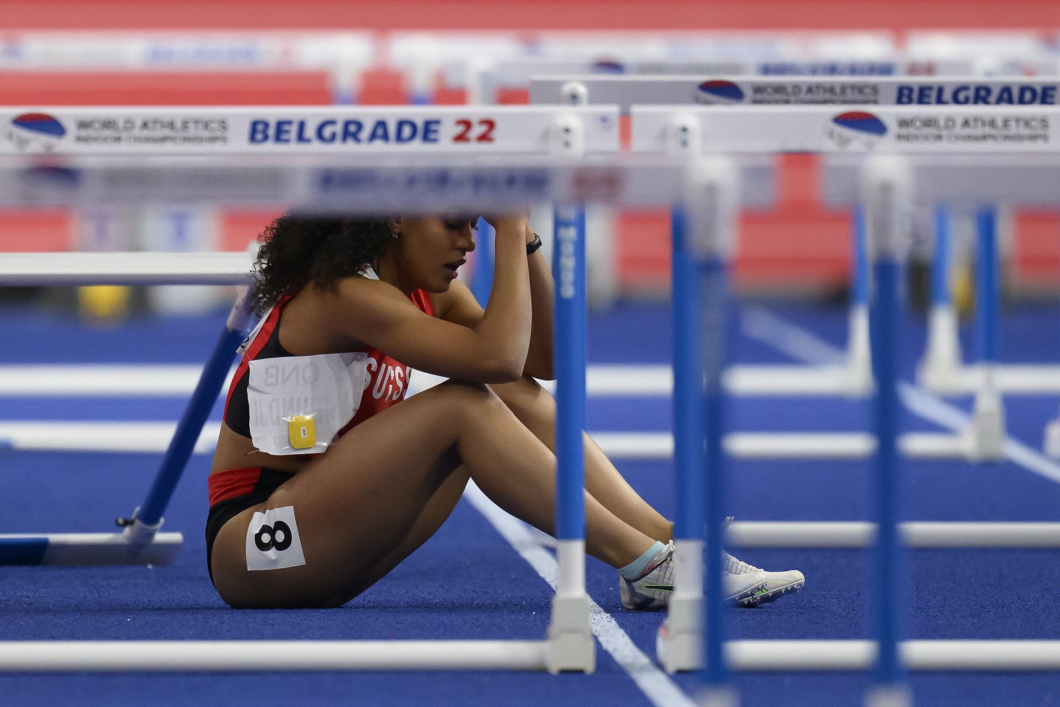 epa09836785 Ditaji Kambundji of Switzerland reacts after crashing during the Women&#039;s 60m Final at the IAAF World Athletics Indoor Championships in Belgrade, Serbia, 19 March 2022. EPA/ANTHONY ANE ...