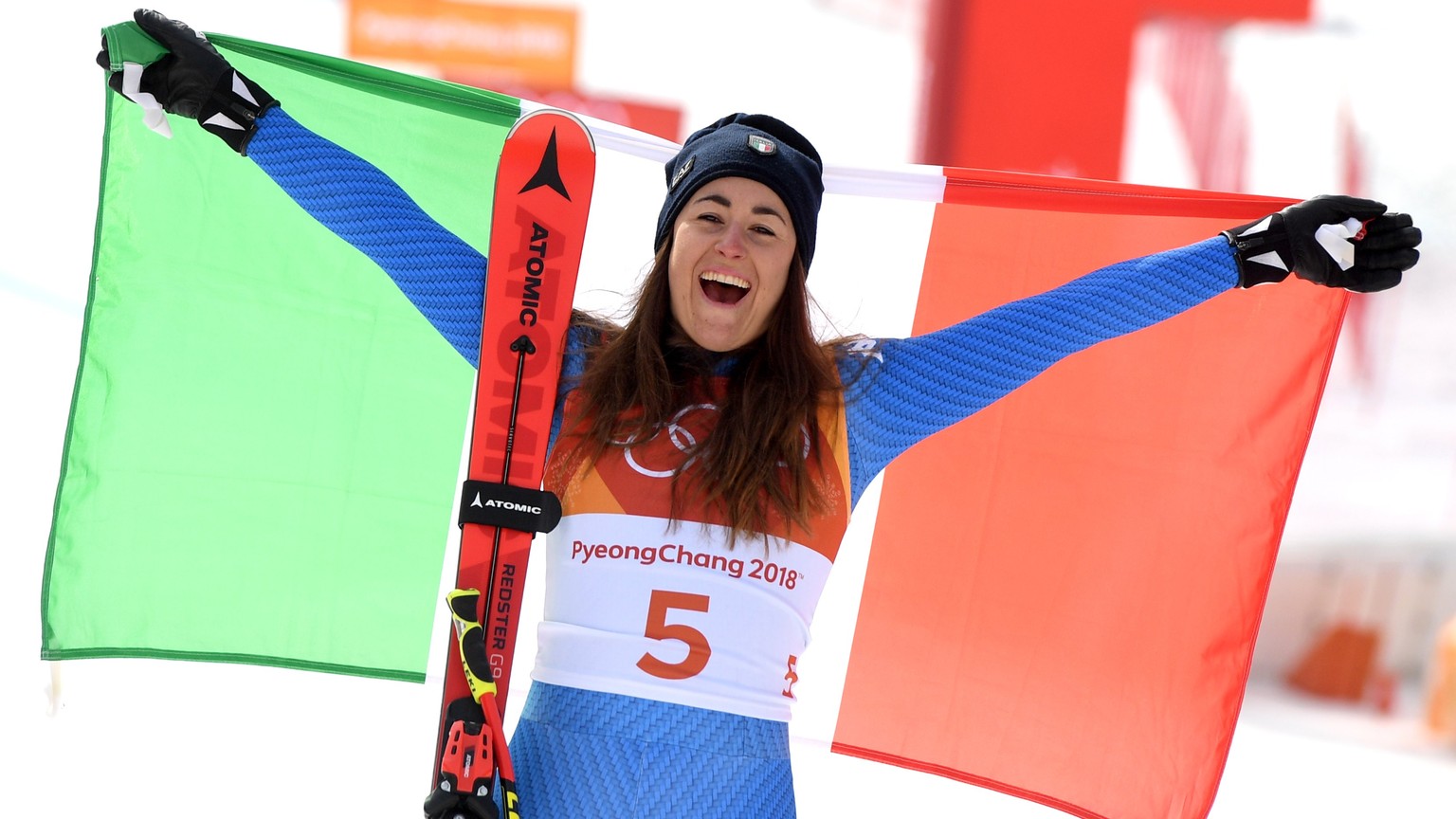 epa06548336 Gold medal winner Sofia Goggia of Italy celebrates during the venue ceremony for the Women's Downhill race at the Jeongseon Alpine Centre during the PyeongChang 2018 Olympic Games, South K ...