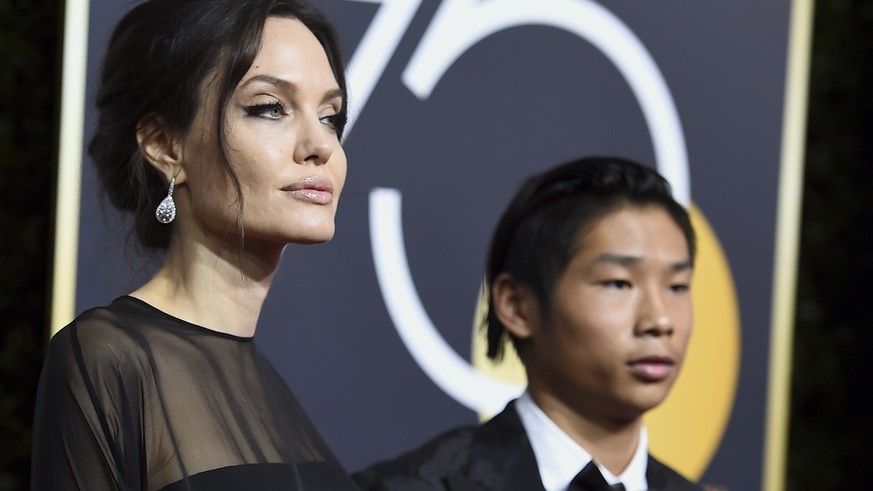 Angelina Jolie, left, and Pax Jolie-Pitt arrive at the 75th annual Golden Globe Awards at the Beverly Hilton Hotel on Sunday, Jan. 7, 2018, in Beverly Hills, Calif. (Photo by Jordan Strauss/Invision/A ...