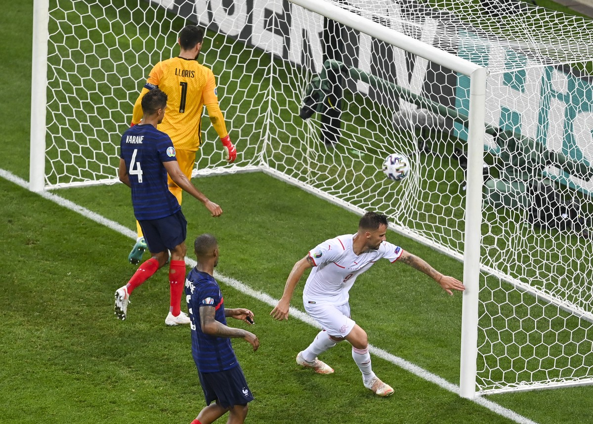 Switzerland's Haris Seferovic, right, reacts after scoring his team's second goal during the Euro 2020 soccer championship round of 16 match between France and Switzerland at National Arena  ...