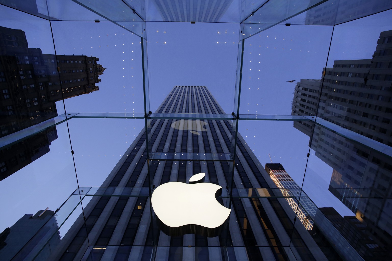 FILE - In this Sept. 5, 2014, file photo, the Apple logo hangs in the glass box entrance to the company&#039;s Fifth Avenue store in New York. Apple is appealing a European Union order to collect a re ...