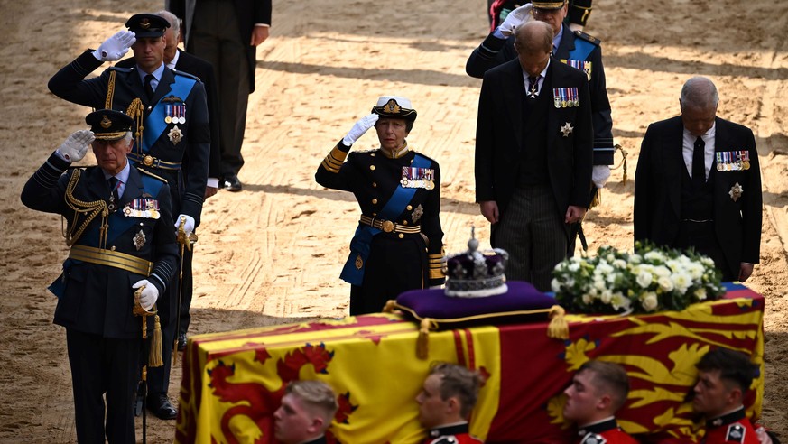 Britain&#039;s King Charles III, Britain&#039;s Prince William, Britain&#039;s Princess Anne, salute alongside Britain&#039;s Prince Andrew, as the coffin of Queen Elizabeth II, adorned with a Royal S ...