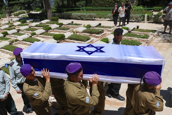 epa11403361 Soldiers carry the coffin of killed Israeli soldier Almog Shalom during the funeral at Mount Herzel military cemetery in Jerusalem, 11 June 2024. Four Israeli soldiers were killed and six  ...