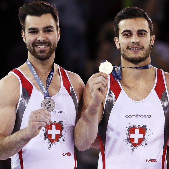 epa05923627 Pablo Braegger of Switzerland (C) poses with his gold medal on the podium after winning the men&#039;s high bar final during the 2017 Artistic Gymnastics European Championships at the Poli ...