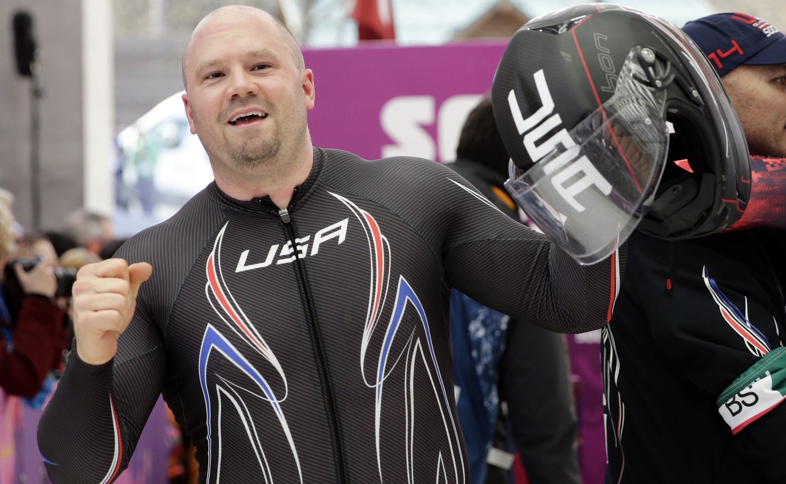 FILE - In this Feb. 23, 2014 file photo, the driver of United States USA-1, Steven Holcomb, acknowledges the crowd after the team won the bronze medal during the men&#039;s four-man bobsled competitio ...