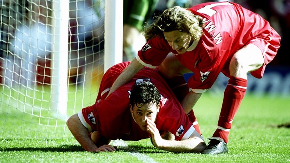 3 Apr 1999: Robbie Fowler of Liverpool is pulled away by team mate Steve McManaman after mimicking cocaine snorting to celebrate his first goal against Everton in the FA Carling Premiership match at A ...