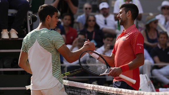 Serbia&#039;s Novak Djokovic, right, is congratulated by Spain&#039;s Carlos Alcaraz after Djokovic won the semifinal match of the French Open tennis tournament in four sets, 6-3, 5-7, 6-1, 6-1, at th ...