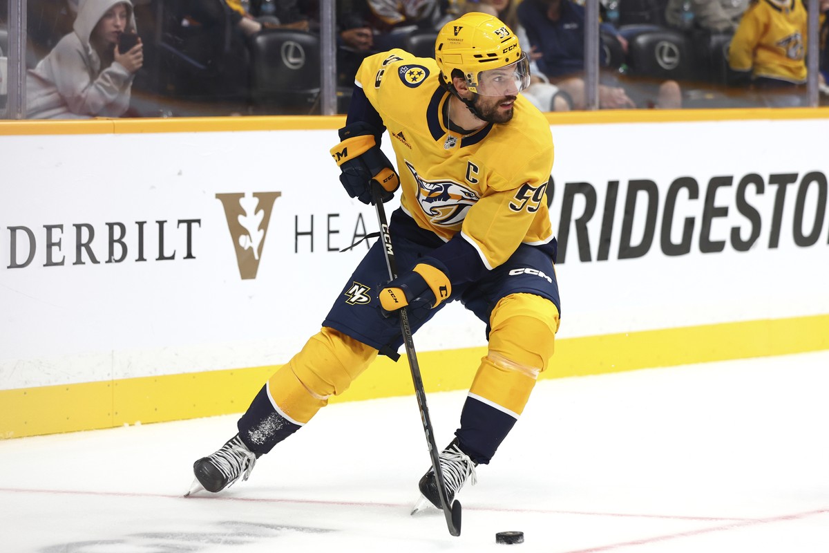Nashville Predators defenseman Roman Josi (59) skates with the puck during the second period of an NHL preseason hockey game, Saturday, Oct. 5, 2024, in Nashville, Tenn. (AP Photo/Johnnie Izquierdo)