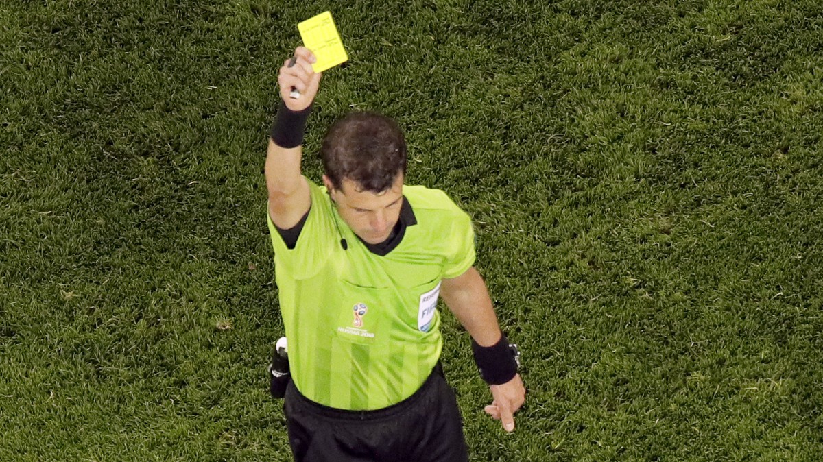 France's Ngolo Kante is shown a yellow card by referee Anders Cunha during the semifinal match between France and Belgium at the 2018 soccer World Cup in the St. Petersburg Stadium in St. Petersb ...