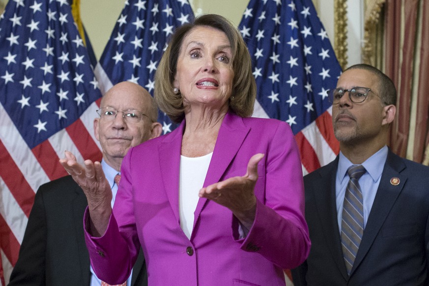 epa07276373 US Speaker of the House Democrat Nancy Pelosi (C) delivers remarks beside Democratic lawmakers while participating in an enrollment ceremony for legislation that will ensure backpay to fur ...