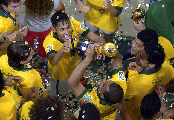 The photo provided by FIFA shows Brazil's Neymar celebrating with his teammates after winning the Confederations Cup final between Brazil and Spain at Maracana stadium in Rio de Janeiro, Brazil, ...