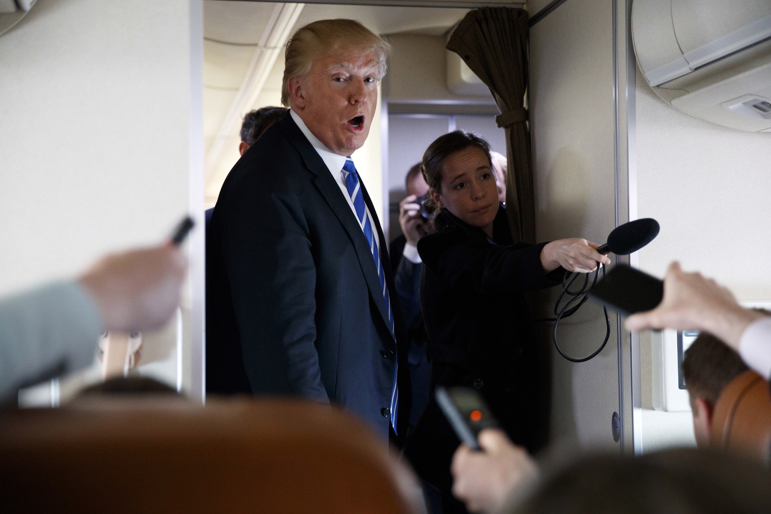 President Donald Trump talks with reporters aboard Air Force One on a flight to Andrews Air Force Base, Md., Thursday, April 5, 2018. (AP Photo/Evan Vucci)