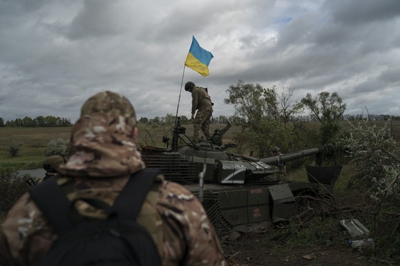 FILE - A Ukrainian national guard serviceman stands atop a destroyed Russian tank in an area near the border with Russia, in Kharkiv region, Ukraine, Sept. 19, 2022. A swift Ukrainian counteroffensive ...