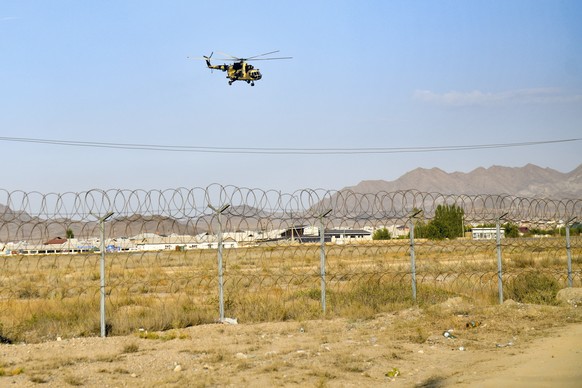 A military helicopter flies over the Kyrgyz-Tajik border near Batken, southwestern Kyrgyzstan, Saturday, Sept. 17, 2022. The fighting on the border between Kyrgyzstan and Tajikistan started Wednesday, ...