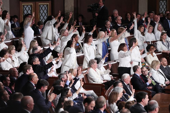 epa08193640 Congresswomen react as US President Donald J. Trump delivers his State of the Union address during a joint session of congress in the House chamber of the US Capitol in Washington, DC, USA ...