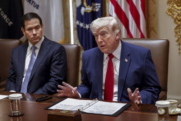 epa12851180 US Secretary of State Marco Rubio (L) looks on as US President Donald J. Trump delivers remarks during a Cabinet meeting in the Cabinet Room of the White House in Washington, DC, USA, 26 M ...