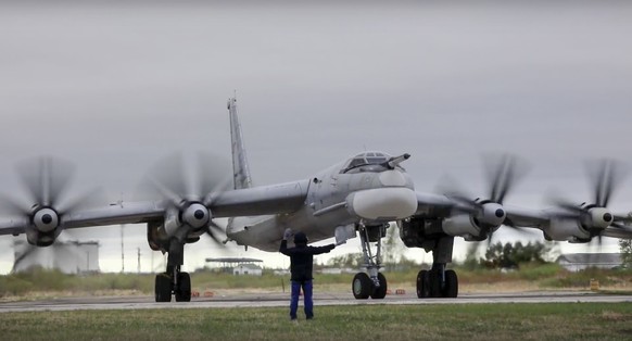 In this photo released by Russian Defense Ministry Press Service on Tuesday, May 24, 2022, A Tu-95 strategic bomber of the Russian air force takes off on a mission at an undisclosed location. (Russian ...