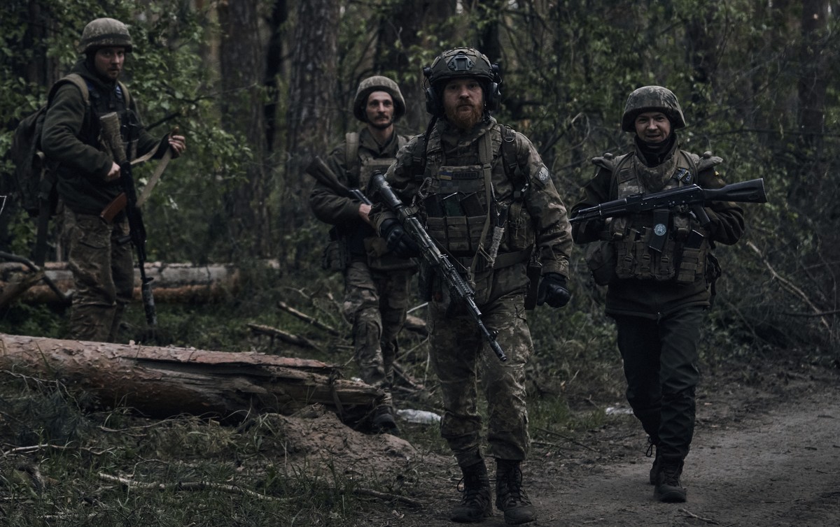 Ukrainian soldiers walk through the forest close to the Russian positions near Kremenna in the Luhansk region, Ukraine, Tuesday, May 9, 2023. (AP Photo/LIBKOS)