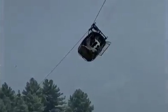 In this image taken from video, a cable car carrying six children and two adults dangles hundreds of meters above the ground in the remote Battagram district, Khyber Pakhtunkhwa, Pakistan on Tuesday,  ...
