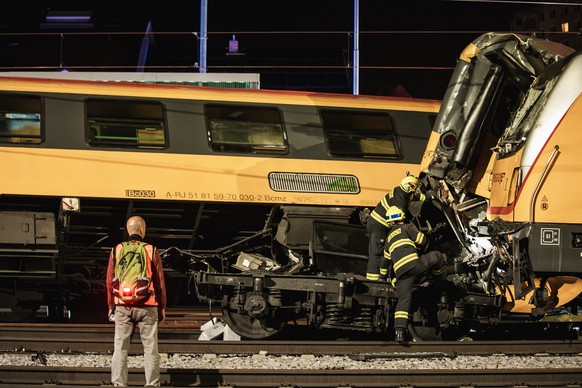 epa11392387 Firefighters work in the aftermath of a train crash in the city of Pardubice, Czech Republic, 05 June 2024. An express train and a freight train collided head-on in Pardubice late 05 June  ...