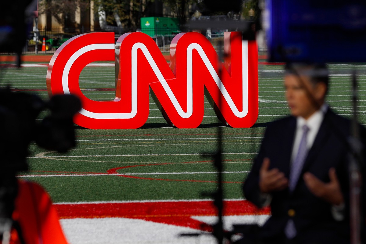 FILE - A journalist records video near a CNN sign on an athletic field outside the Clements Recreation Center where the CNN/New York Times will host the Democratic presidential primary debate at Otter ...
