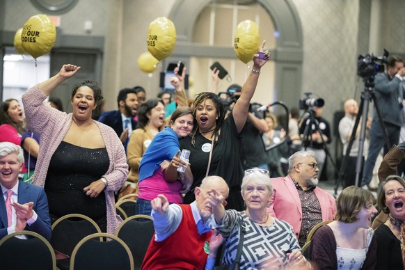 People react on reporting on television about Kentucky Amendment 2 during a Protect Kentucky Access election watch party the Galt House in Louisville, Ky., Tuesday, Nov. 8, 2022. (Ryan C. Hermens/Lexi ...