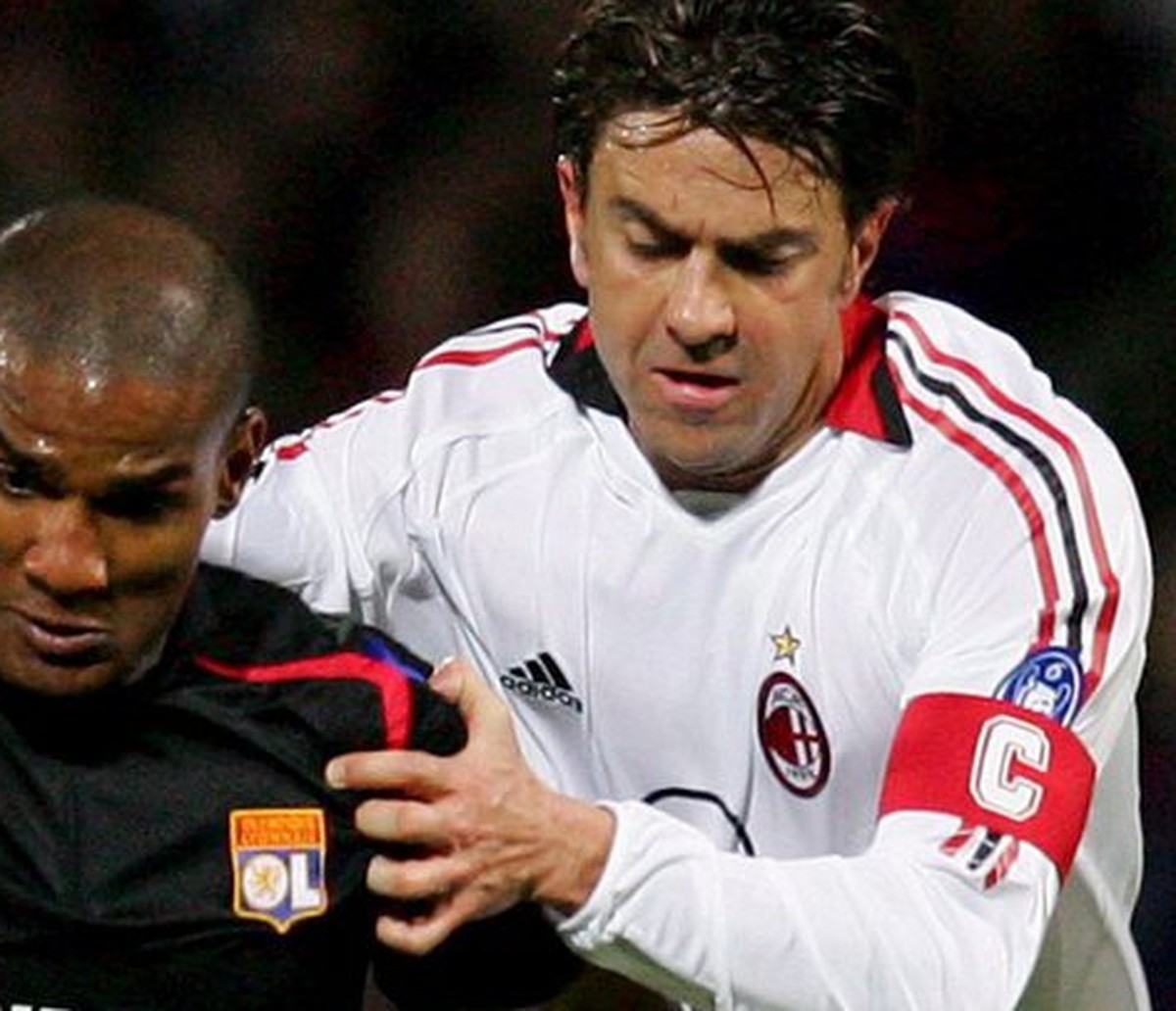 Olympic Lyon's Florent Malouda (L) fights for the ball with Alessandro Costacurta of AC Milan during their Champions League quarterfinal match at Gerland Stadium in Lyon Wednesday 29 March 2006.  ...