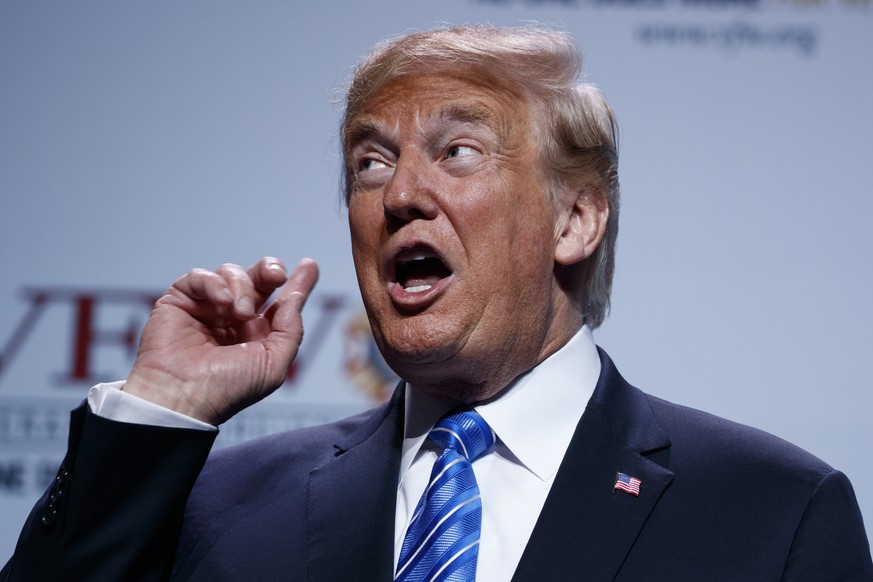 President Donald Trump puts his hand to his ear as music plays during his arrival to speak to the national convention of the Veterans of Foreign Wars, Tuesday, July 24, 2018, in Kansas City, Mo. (AP P ...