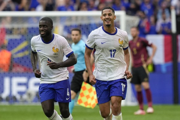 Dayot Upamecano of France, left, and William Saliba celebrate after Belgium&#039;s Jan Vertonghen scored an own goal during a round of sixteen match between France and Belgium at the Euro 2024 soccer  ...