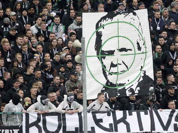 Supporters of Moenchengladbach show a banner with the portrait of Dietmar Hopp during the German Bundesliga soccer match between Borussia Moenchengladbach and TSG Hoffenheim in Moenchengladbach, Germa ...