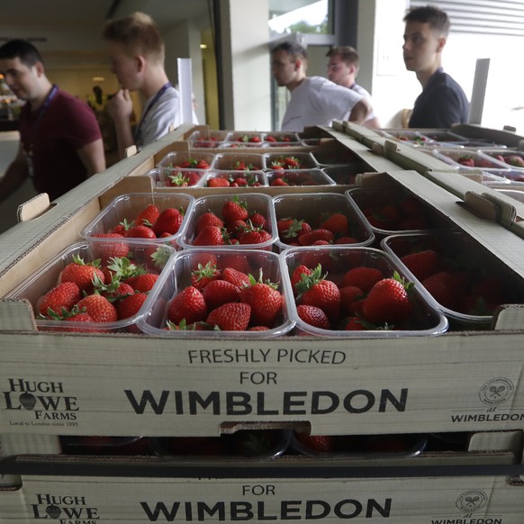 Boxes of strawberries wait to be unloaded during preparations for the Wimbledon Tennis Championships in London, Sunday, June 30, 2019. (AP Photo/Kirsty Wigglesworth)
